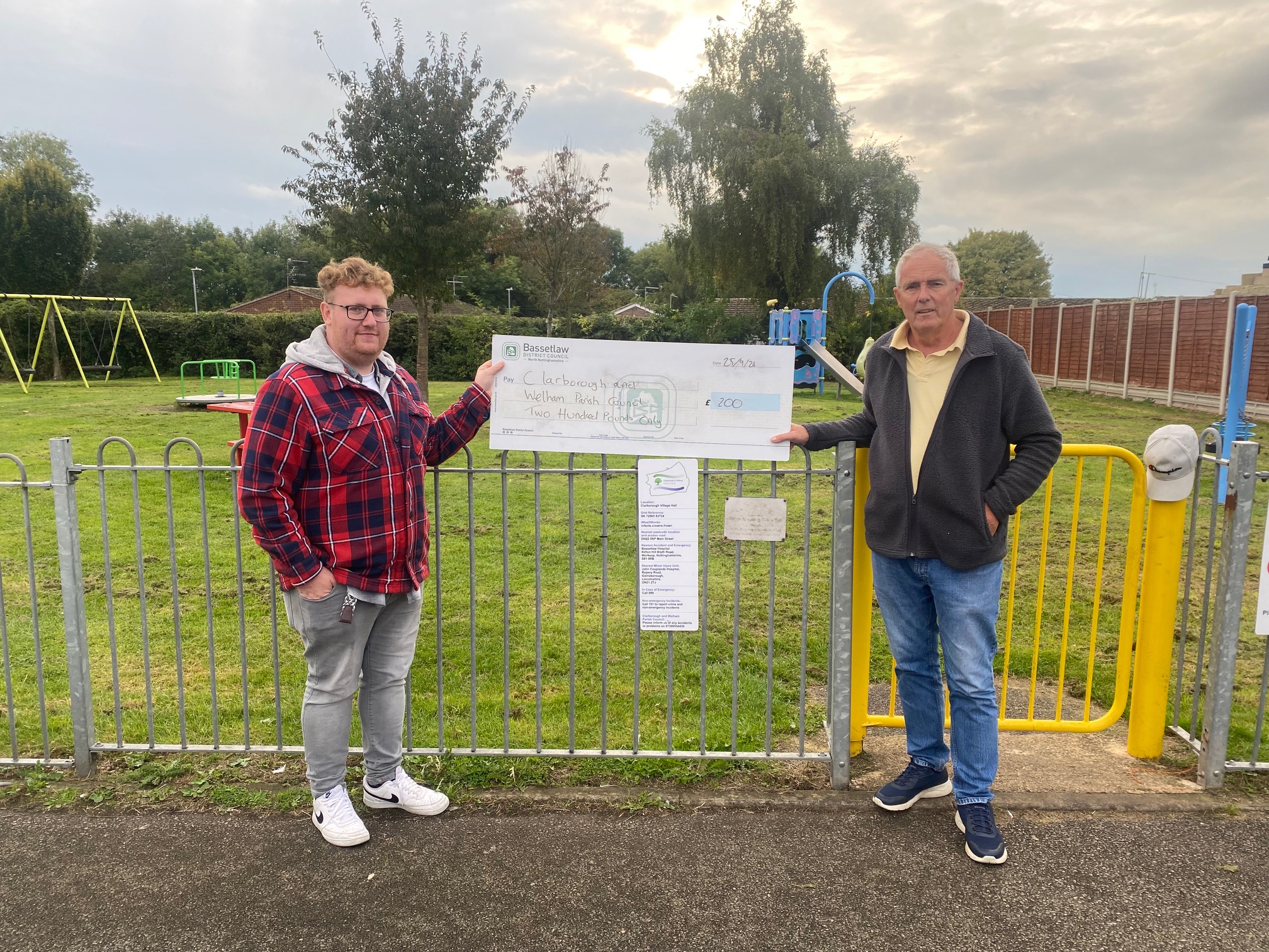 Cllr Fraser McFarland handing over a large cheque of £200 to Chair Phil Gibson